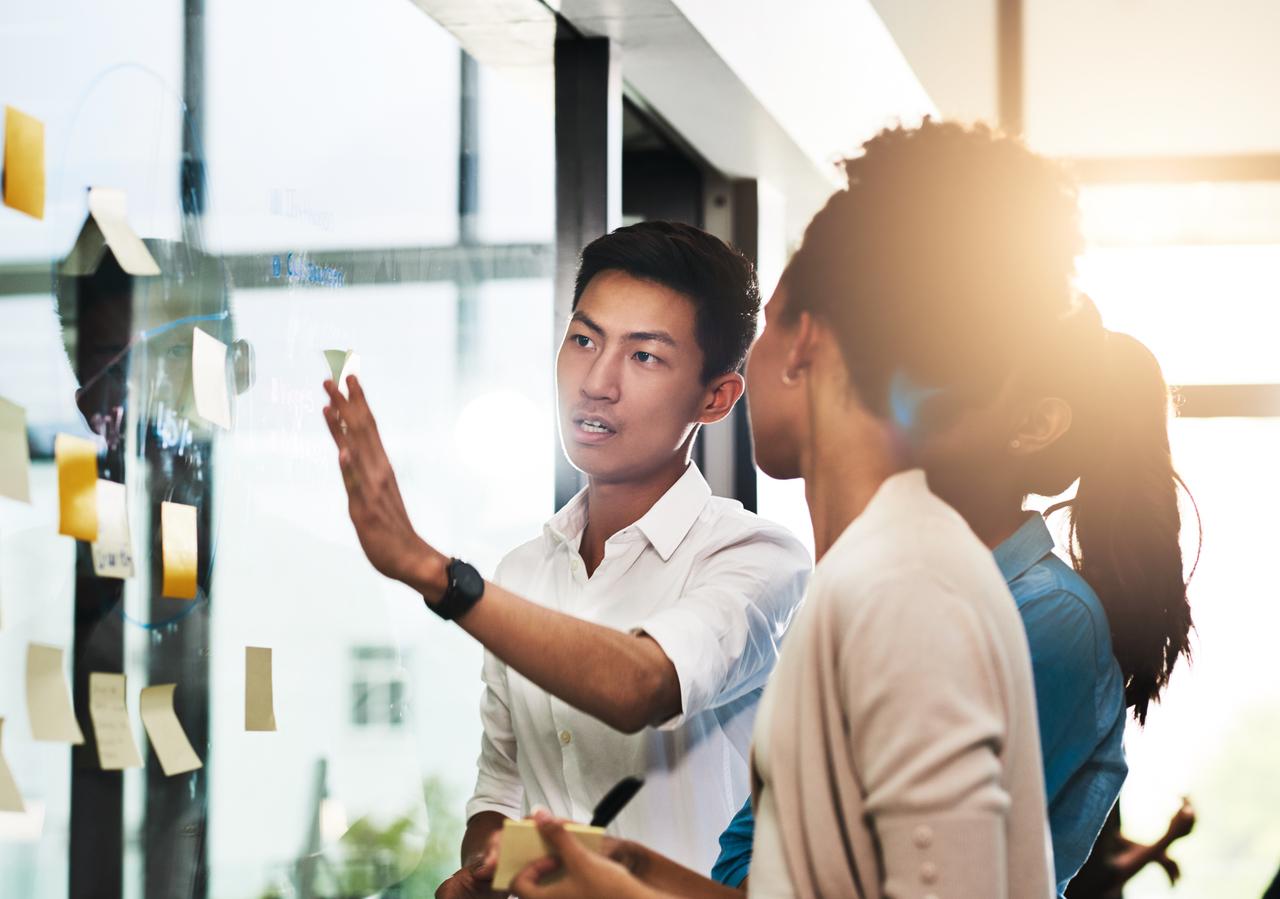 Shot of a group of young business people having a brainstorming session in a modern office