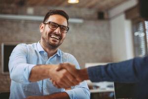 Businessman shaking hands with partner.