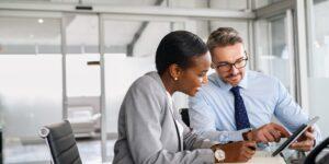 two business partners looking at a tablet