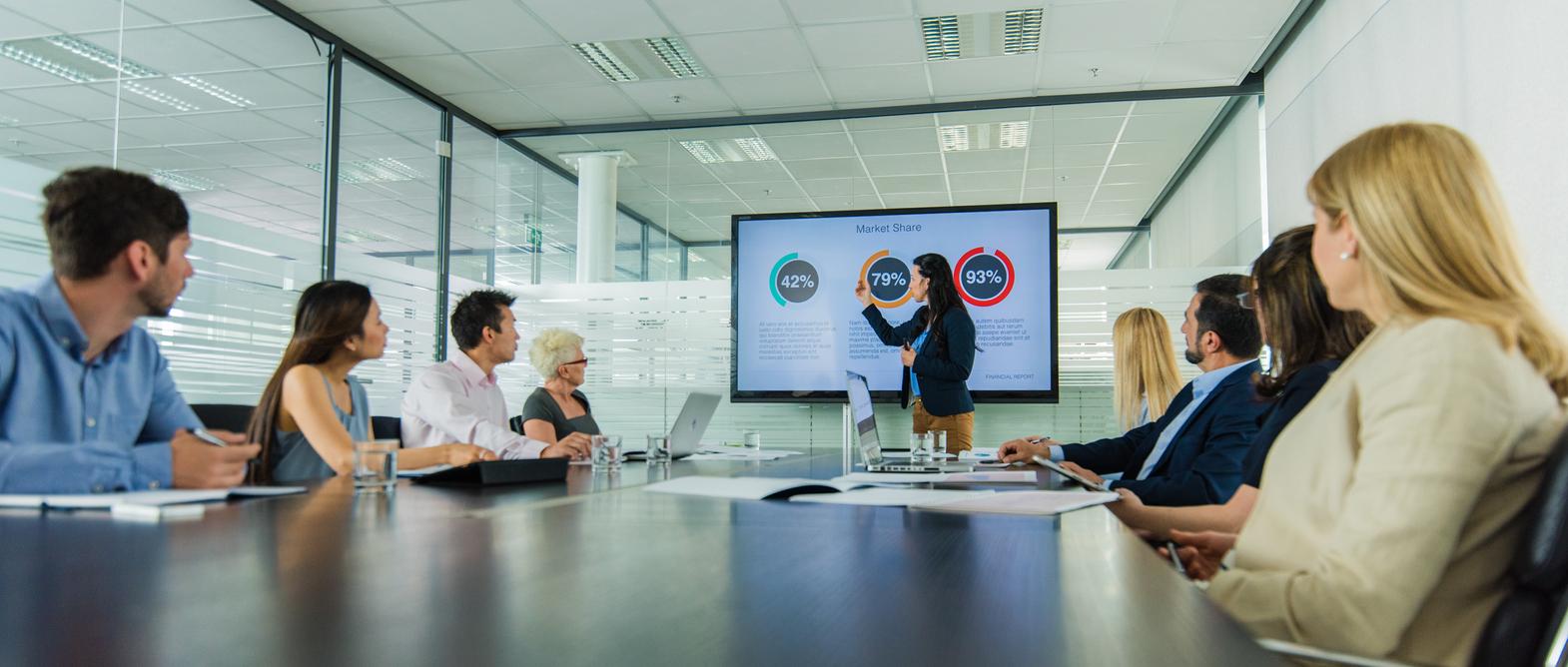 Businesswoman giving presentation in conference room.