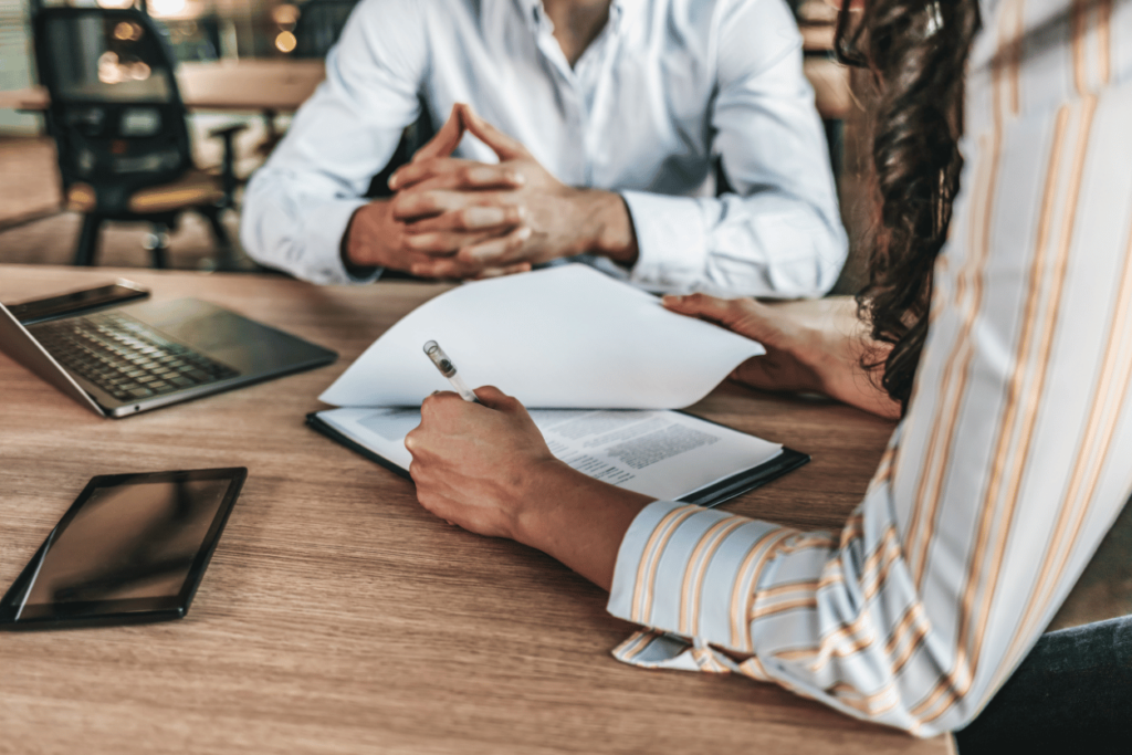 Allianz + Pearl-Plaza customer story feature image talking about customer experience in insurance - image of two business people talking at a table