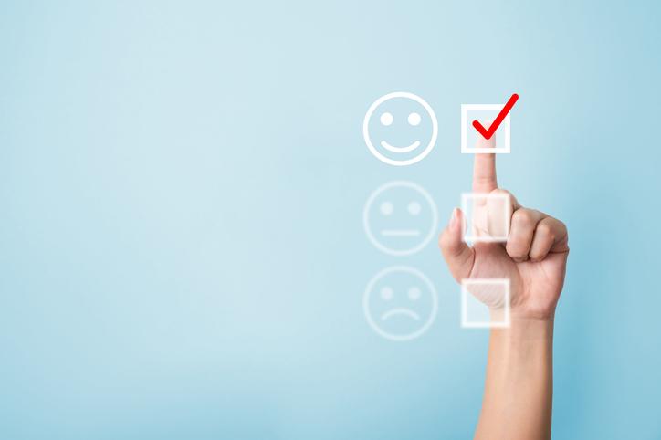 Customer selecting emoji to reflect experience on questionnaire.